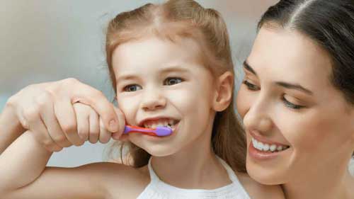 mom-and-daughter-brushing-teeth-min